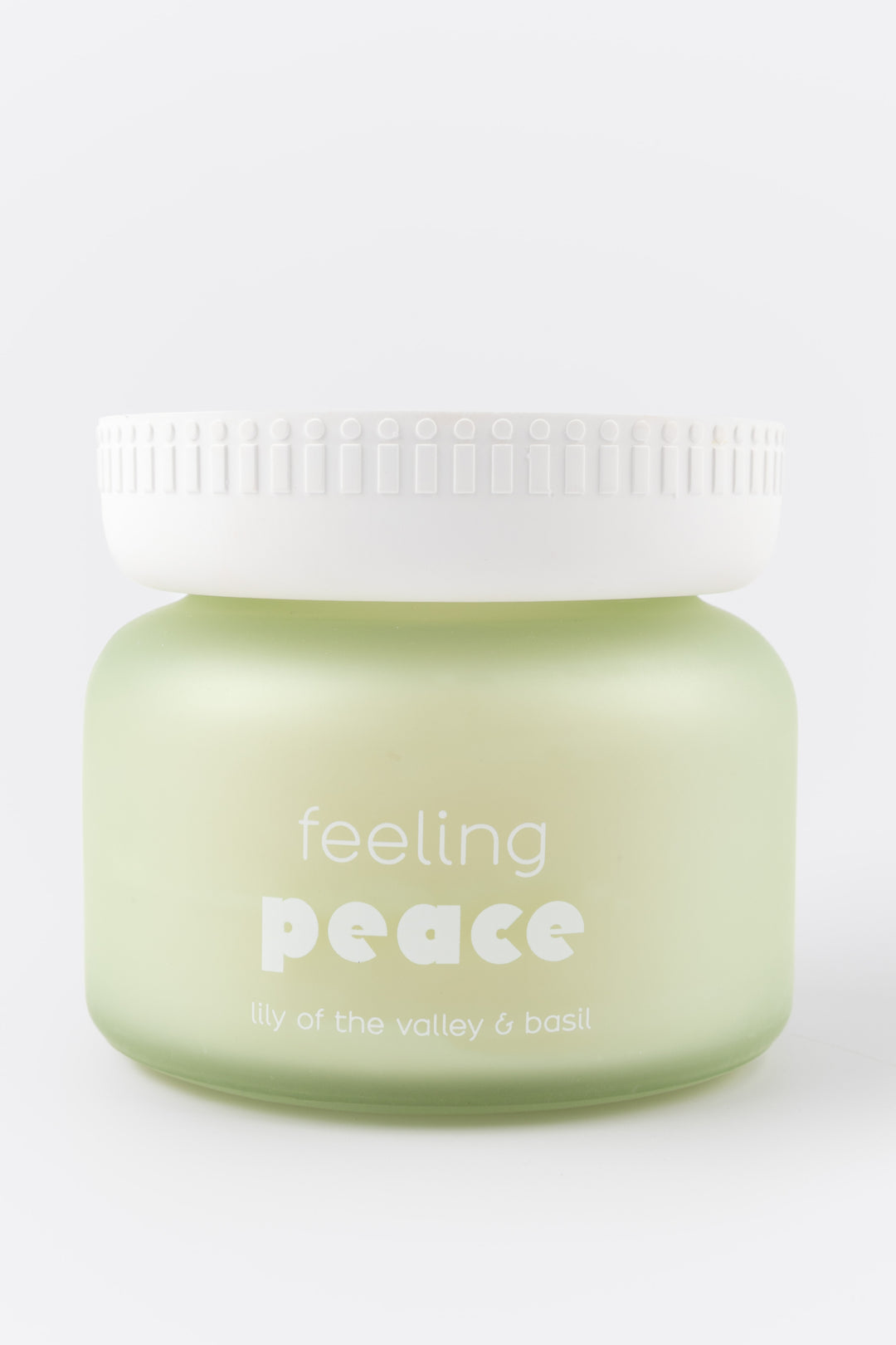 candle jar labeled 'feeling peace' on a white background