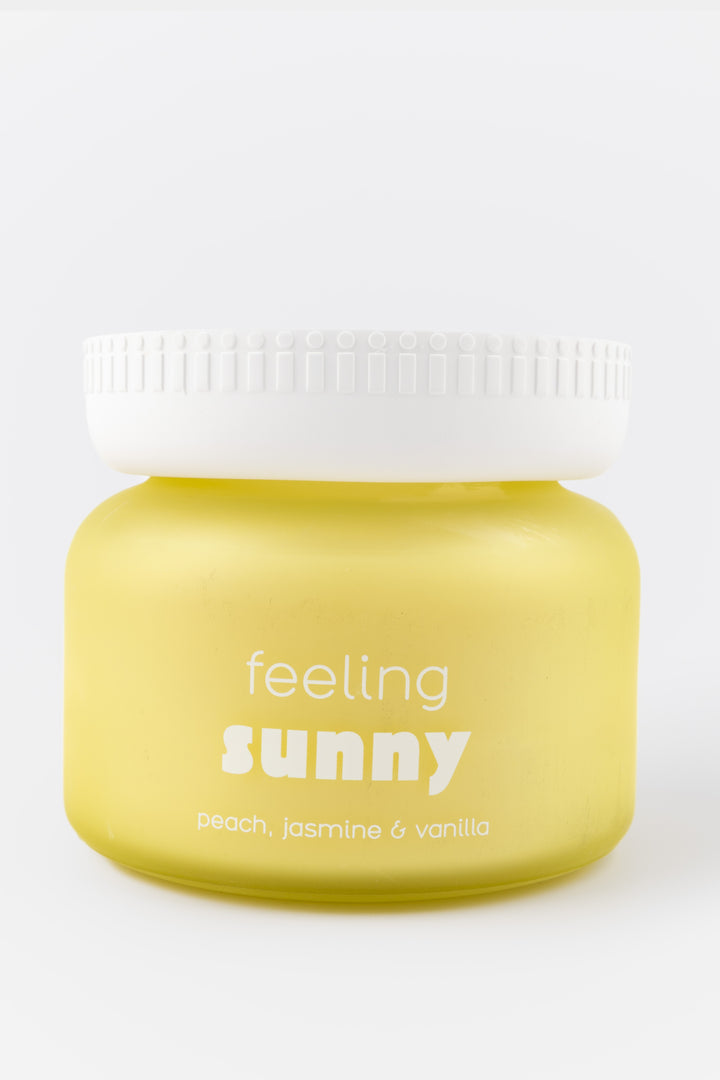 Yellow container with a white lid labeled 'feeling sunny' on a white background