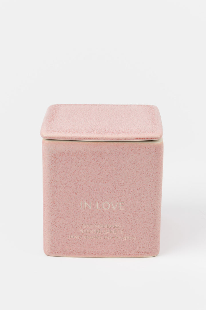 square pink ceramic candle with fitted lid, front view
