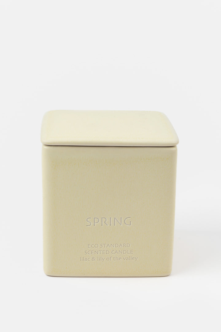 square cream ceramic candle with fitted lid, front view
