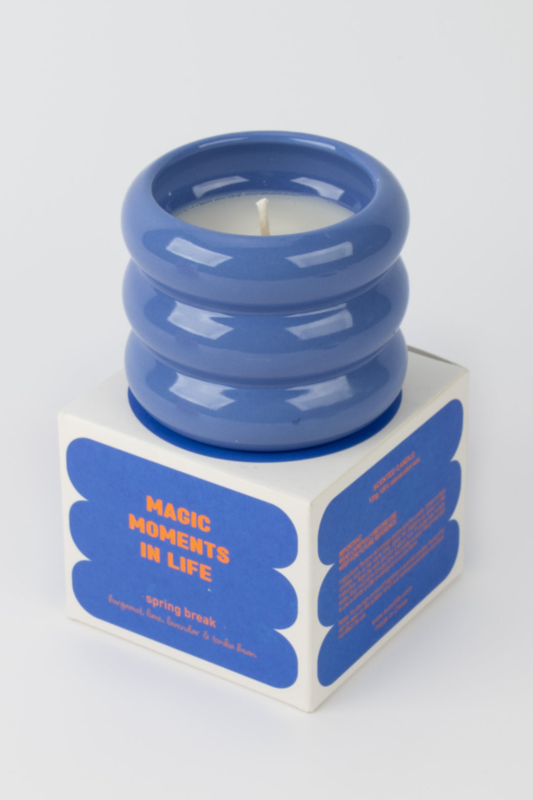 blue ceramic candle placed on matching spring break packaging box
