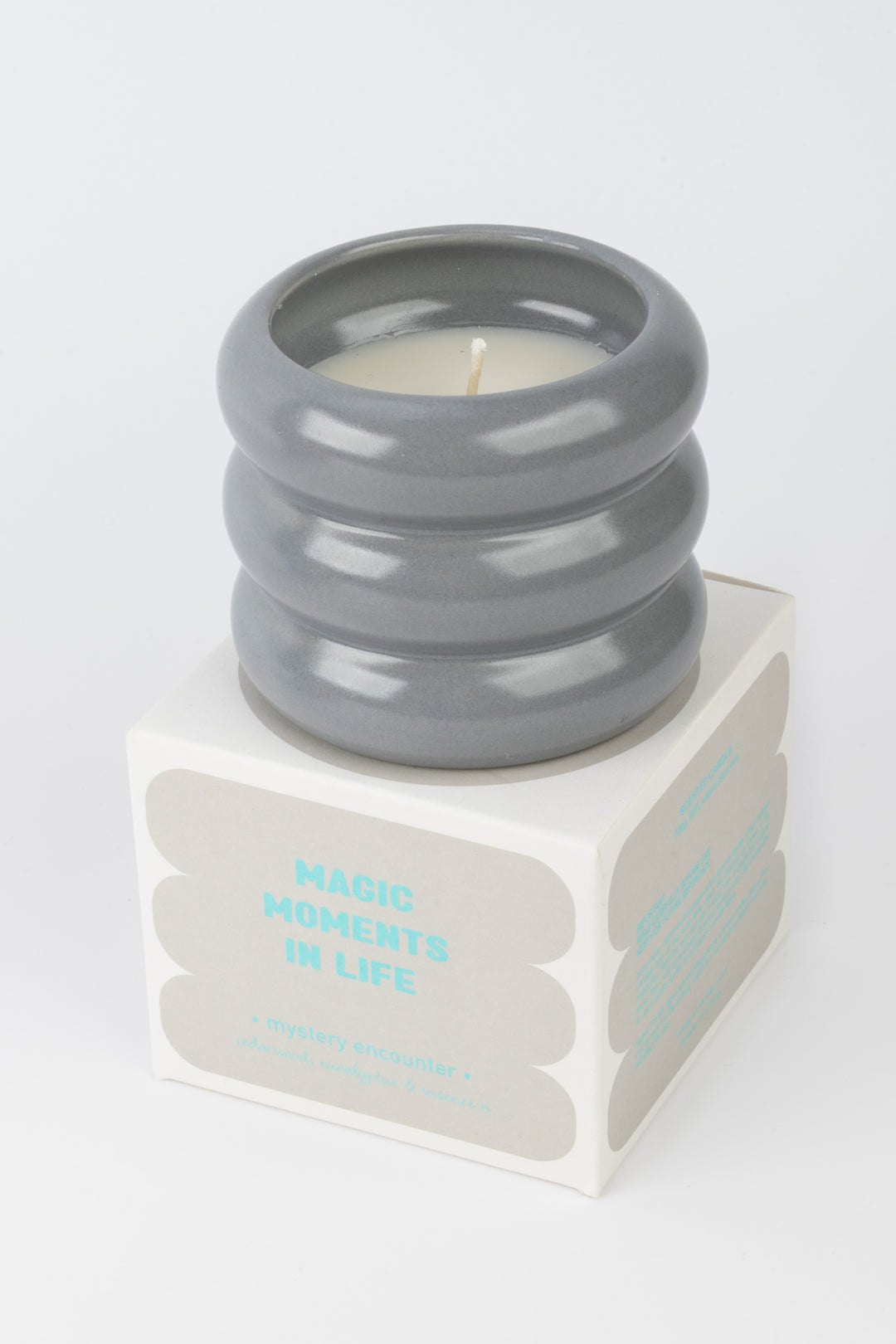 grey ceramic candle placed on matching packaging box
