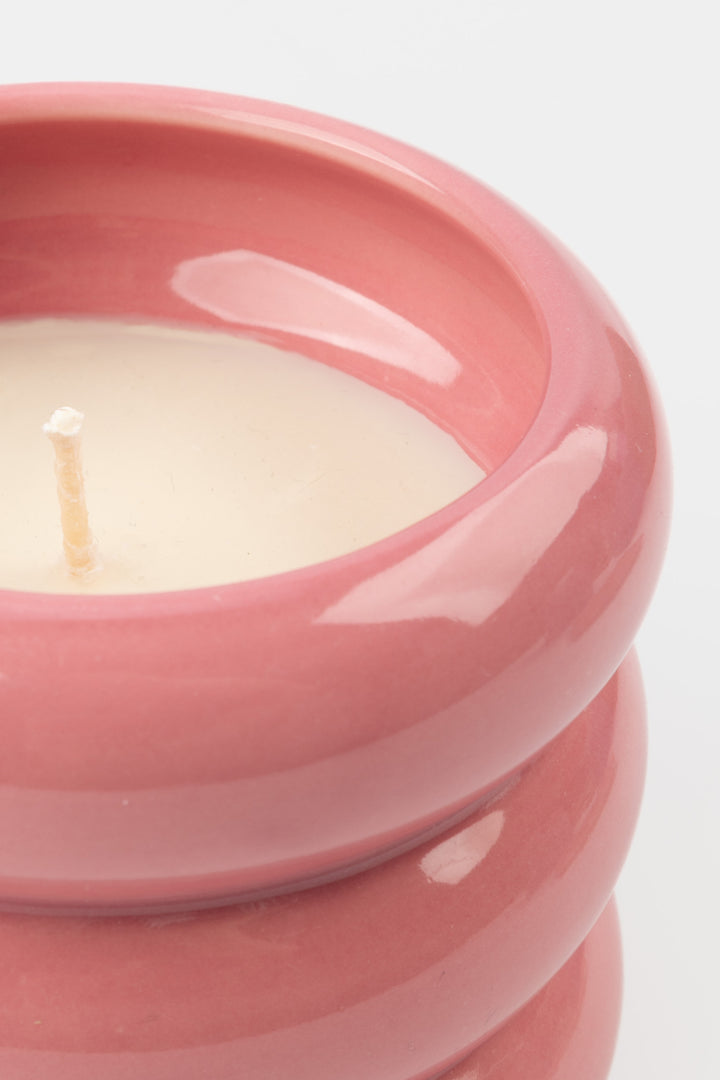 close-up of pink ceramic candle showing glossy rim and white wax
