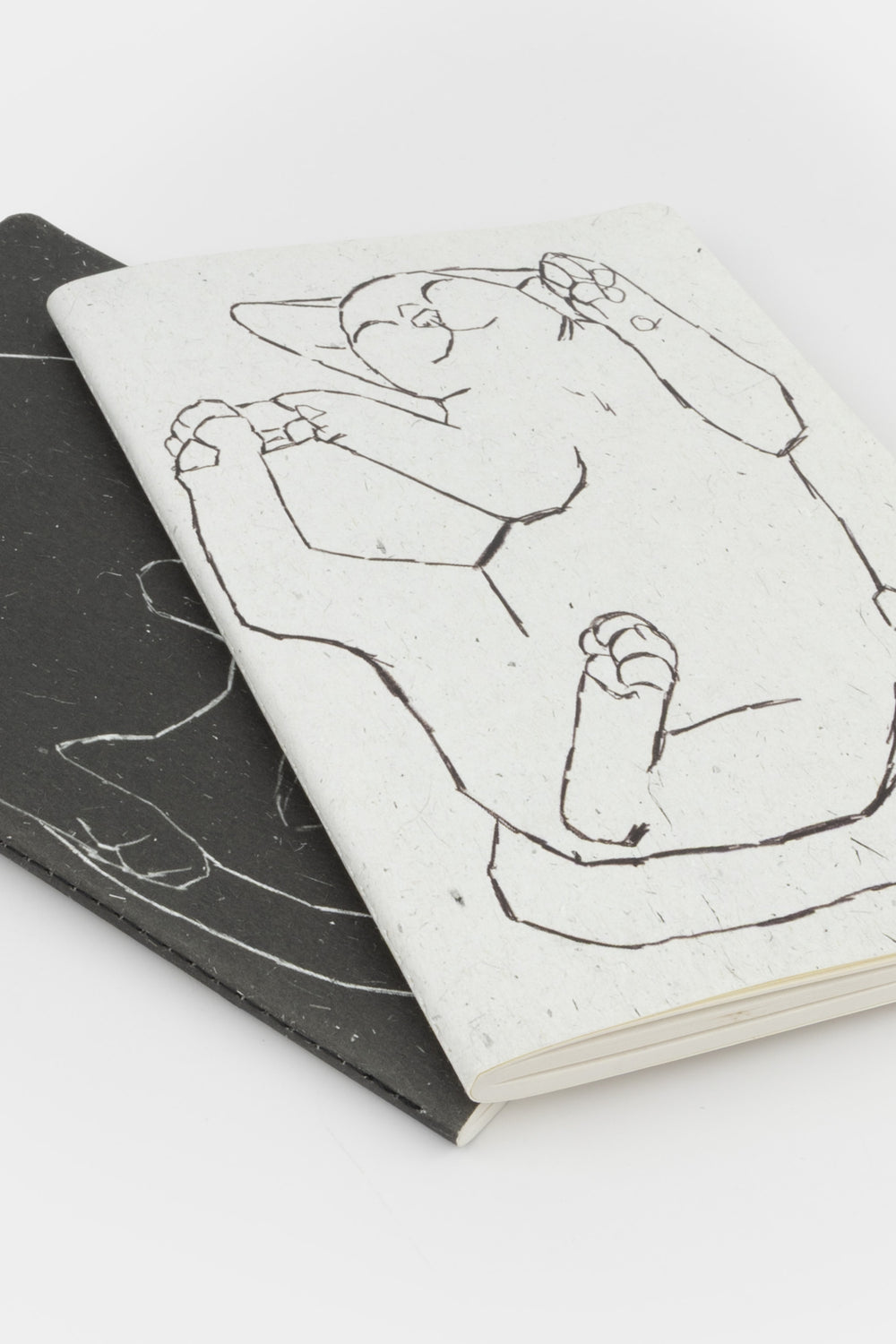 2 notebooks with  black and white illustration of cats 