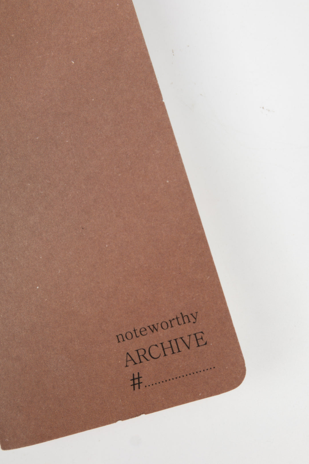 detail of brown notebook with 'noteworthy ARCHIVE' text 