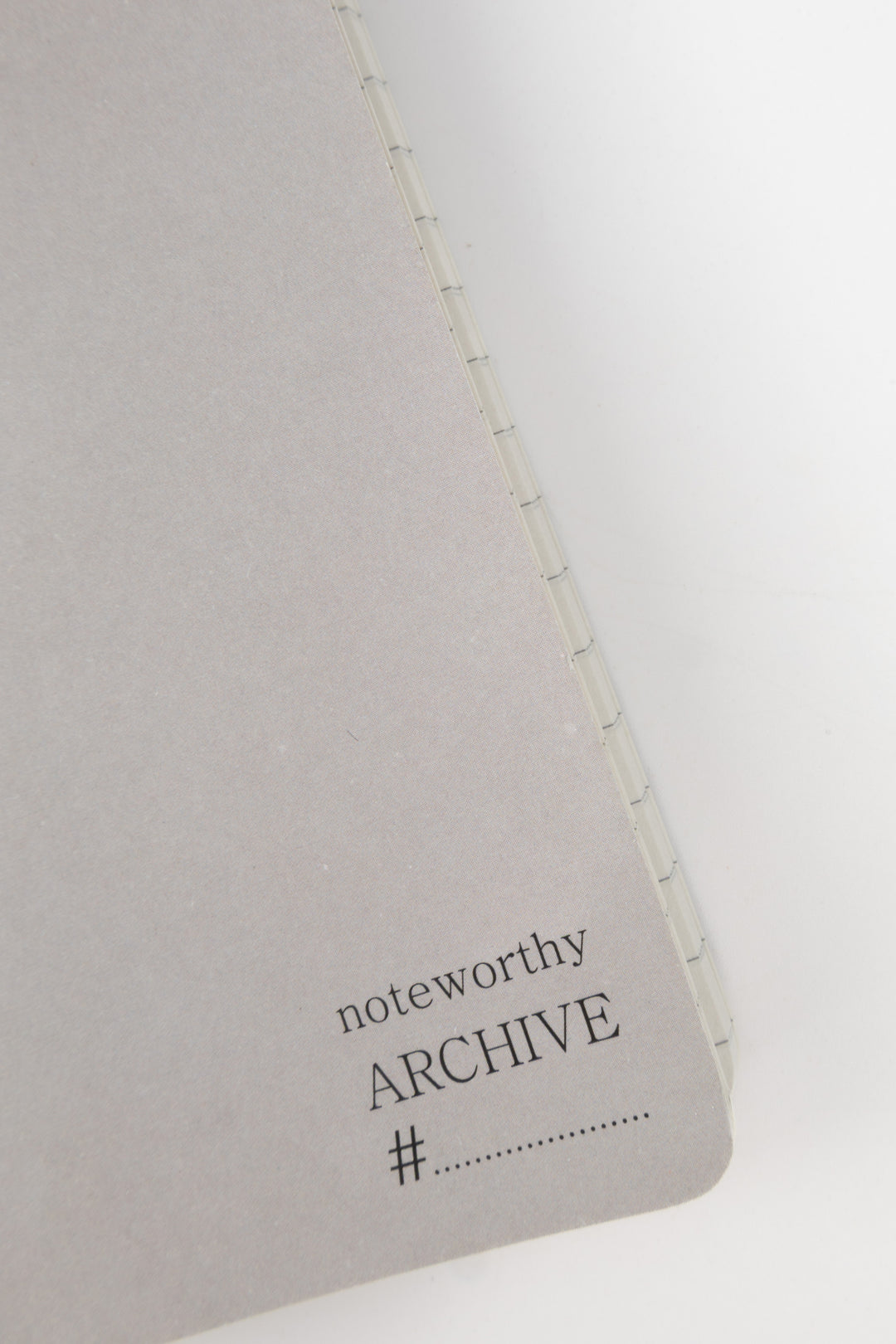detail of grey notebook with 'noteworthy ARCHIVE' text