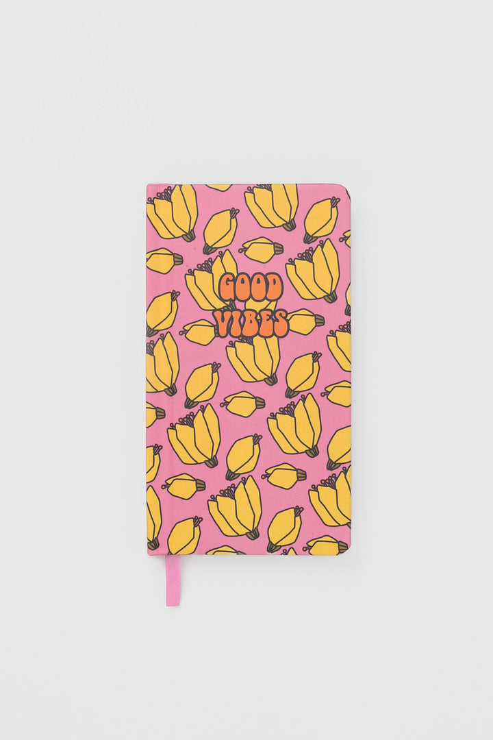 front view of a journal with a fruit pattern and a matching ribbon marker
