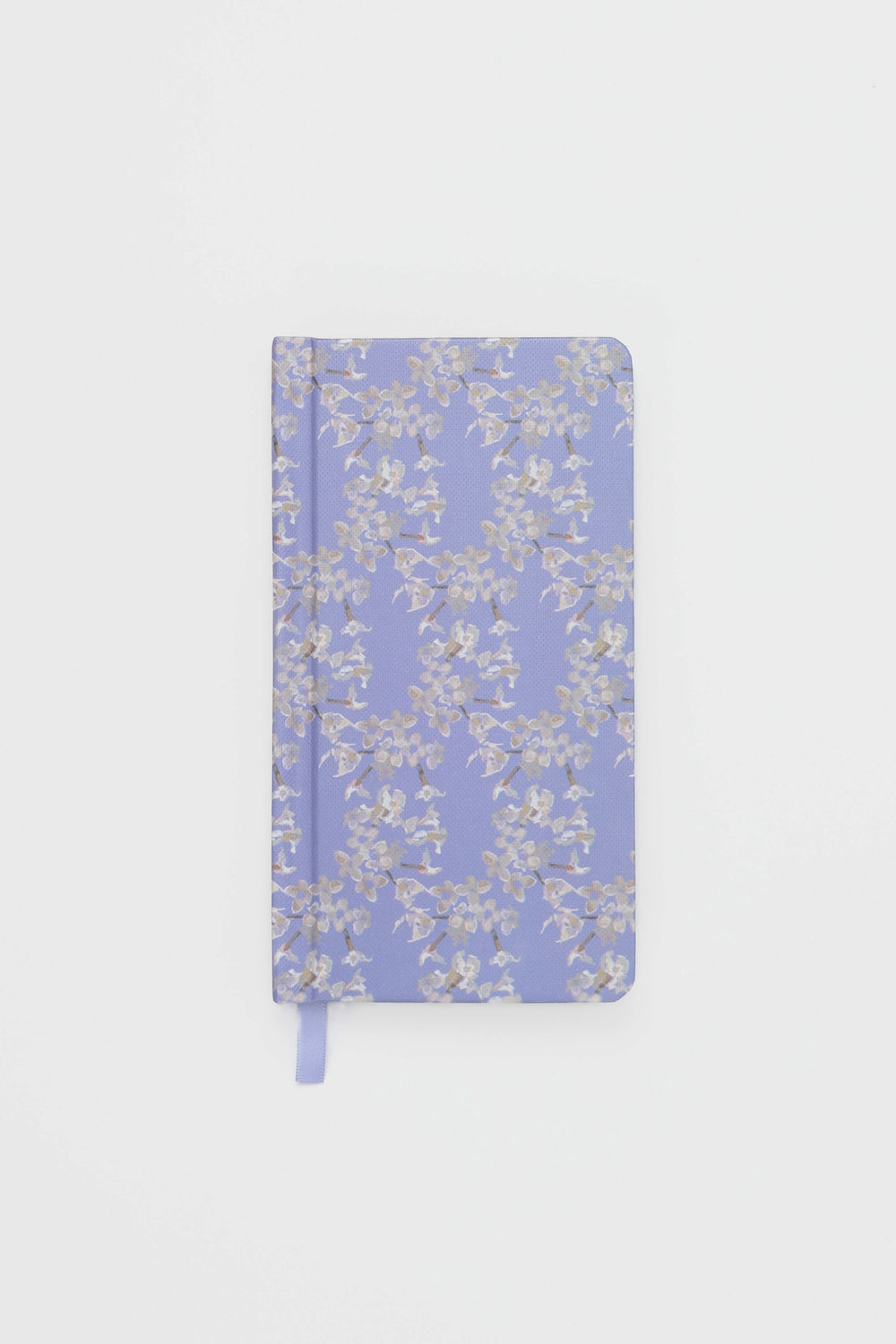 Floral-patterned notebook on a light gray background