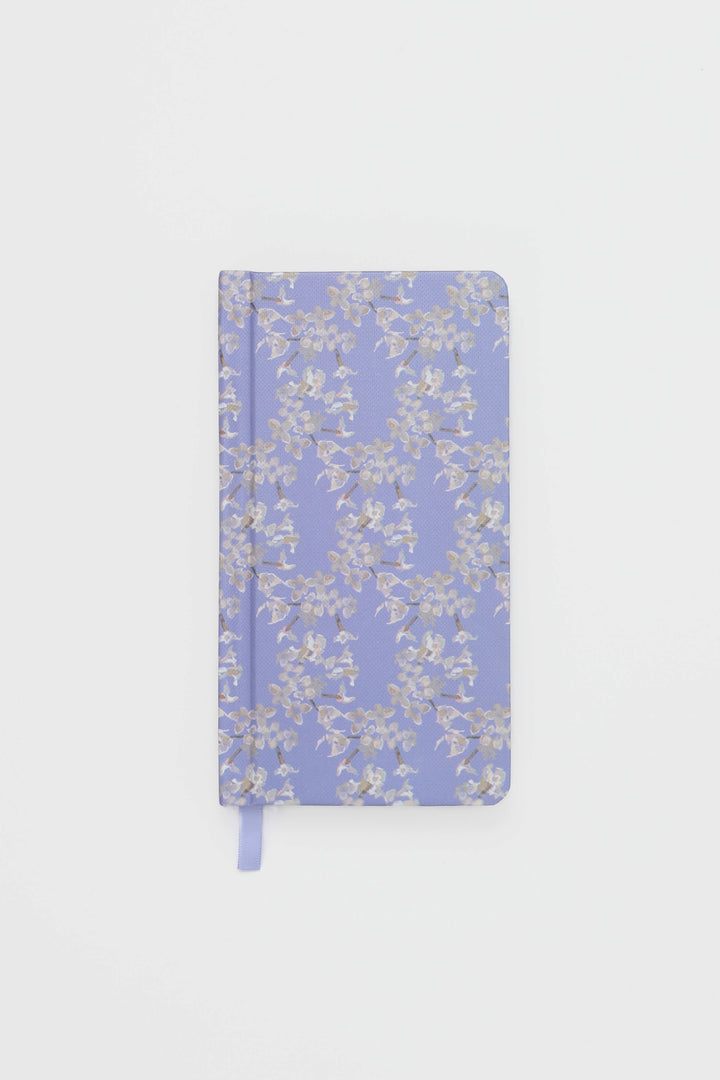 Floral-patterned notebook on a light gray background