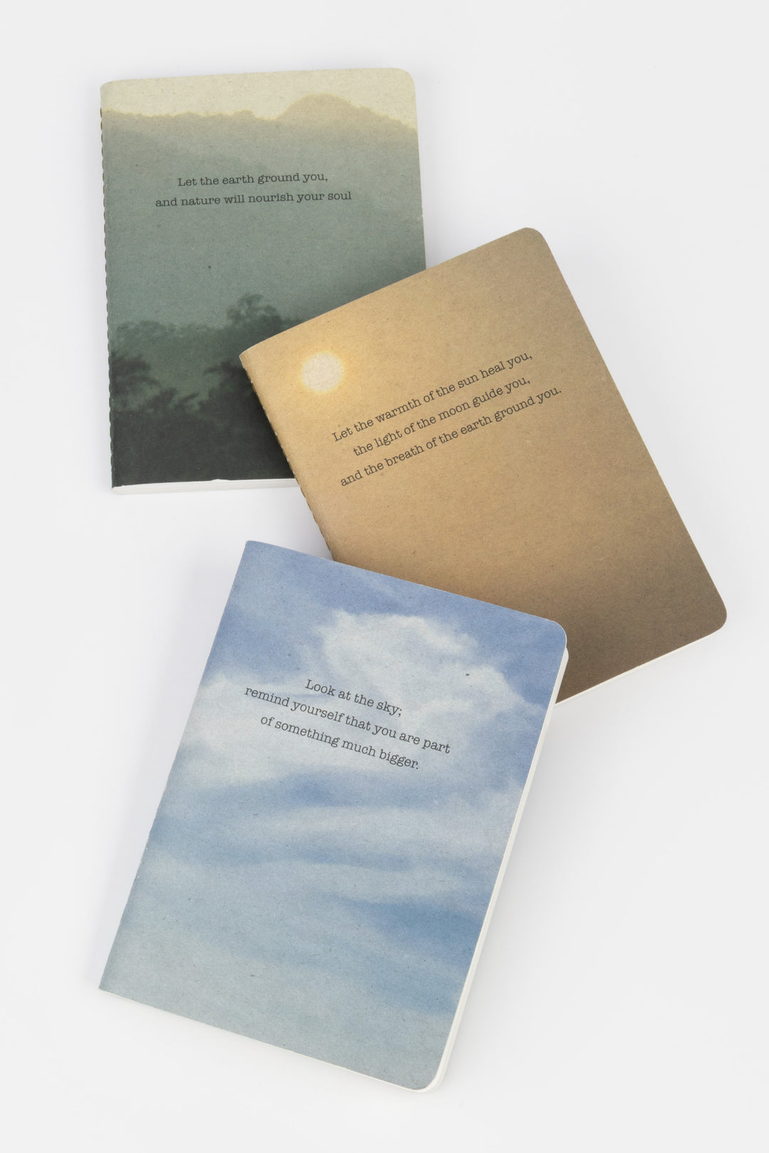 A set of three A6 softcover notebooks with Sky, Sun and Earth nature-inspired covers, made from FSC recycled paper.