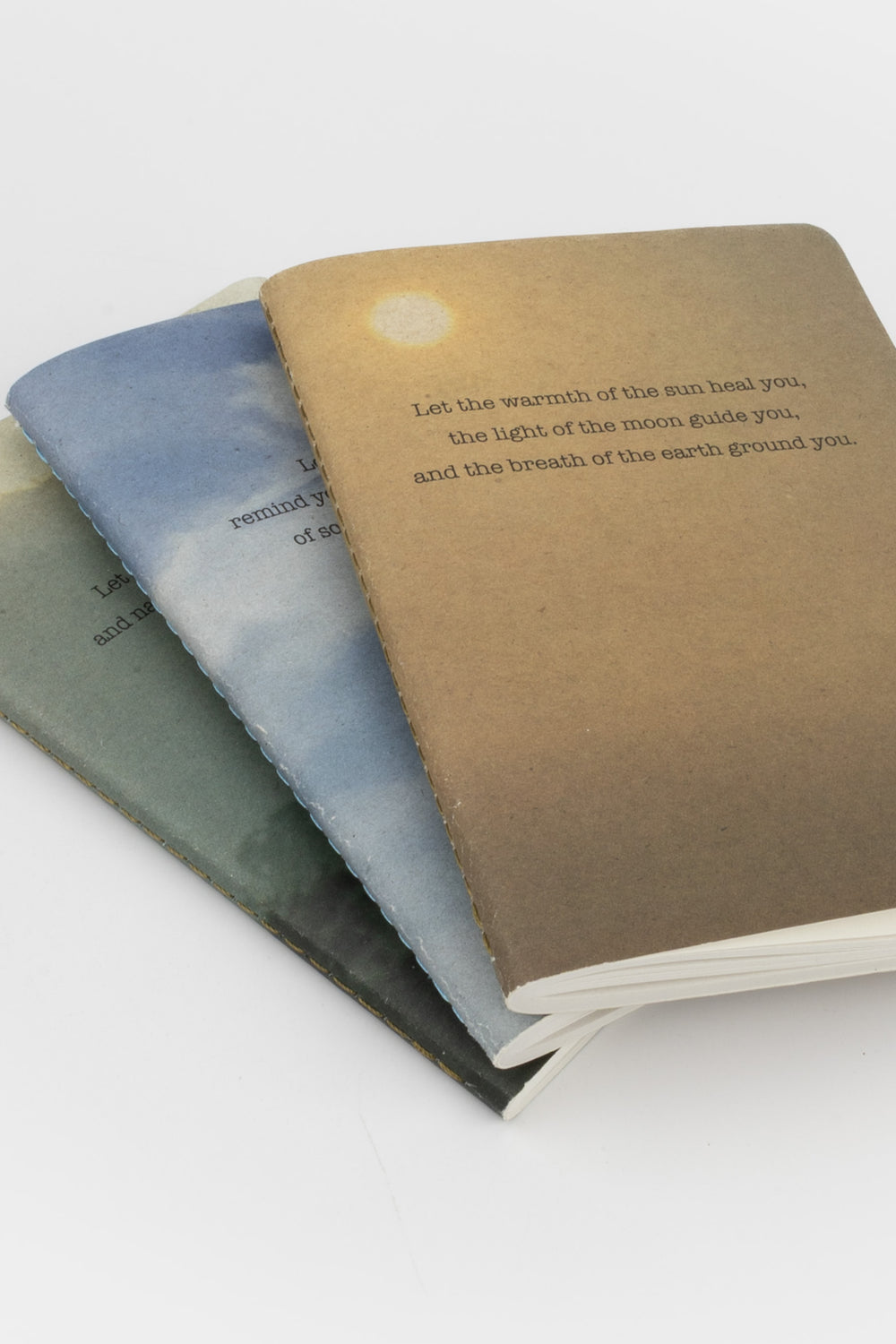 A set of three A6 softcover notebooks with Sky, Sun and Earth nature-inspired covers, made from FSC recycled paper.