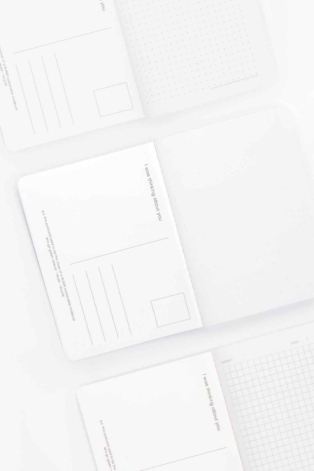 inside of A6 notebooks with different grid patterns and postcard layout on back of cover 