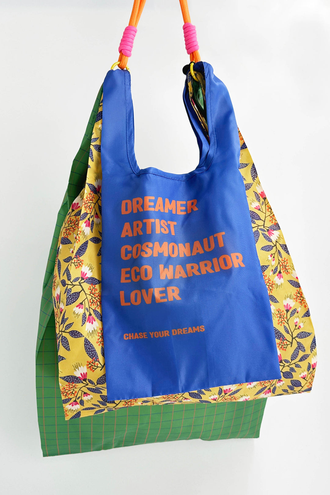 3 reusable shopping bag swith colourful text and patterns on a white background