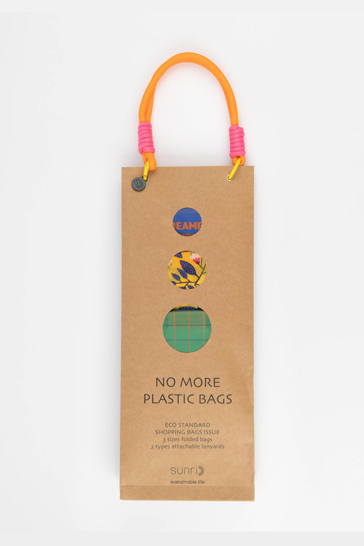 Cardboard packaging for shopping bags with colourful handles and visible branding 