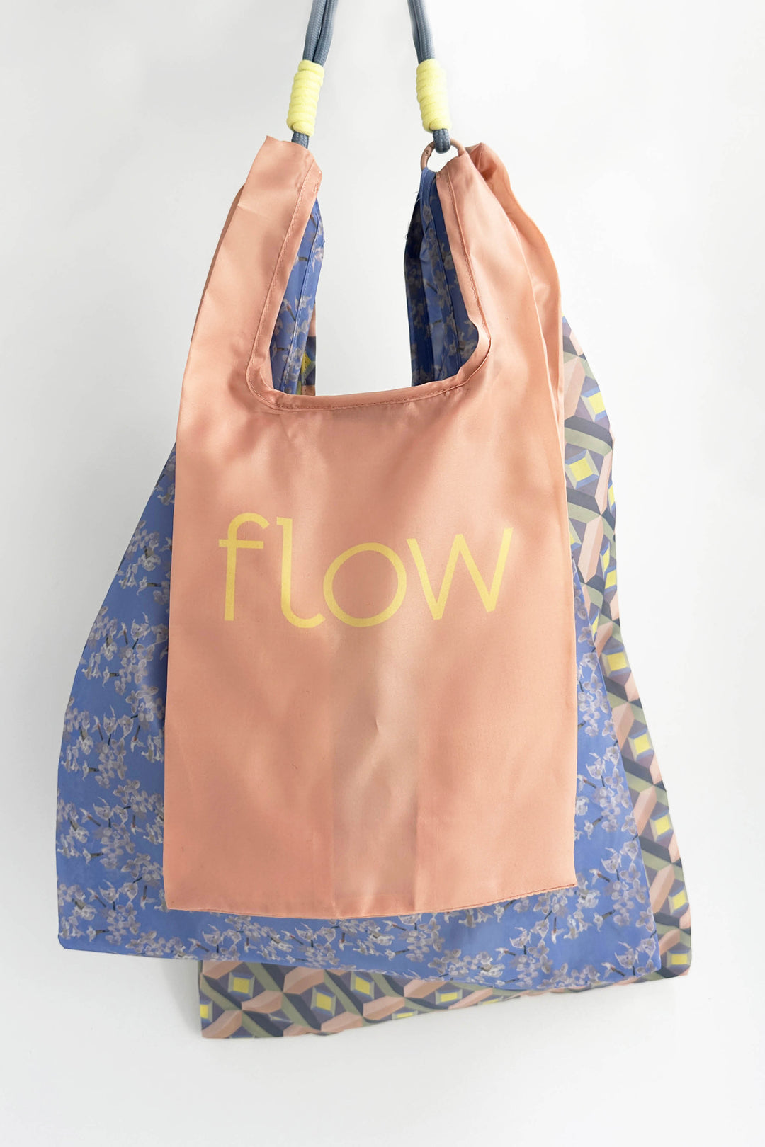 3 reusable shopping bags with colourful text and patterns on a white background