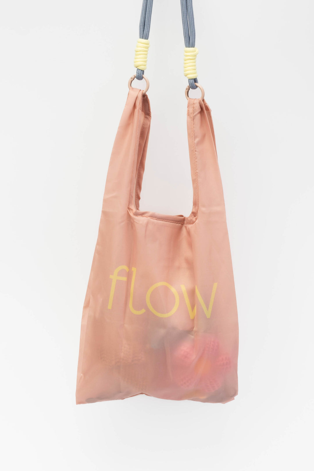 Pink reusable bag with 'flow' text on a white background