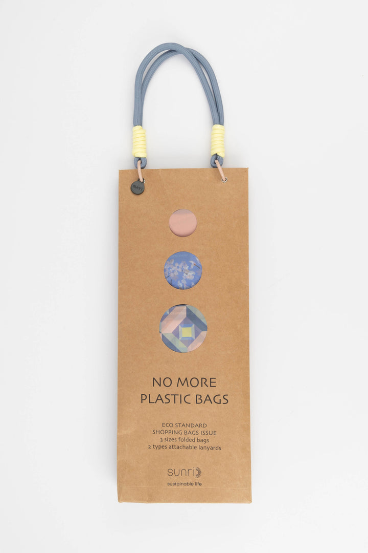 Cardboard packaging for shopping bags with colourful handles and visible branding 