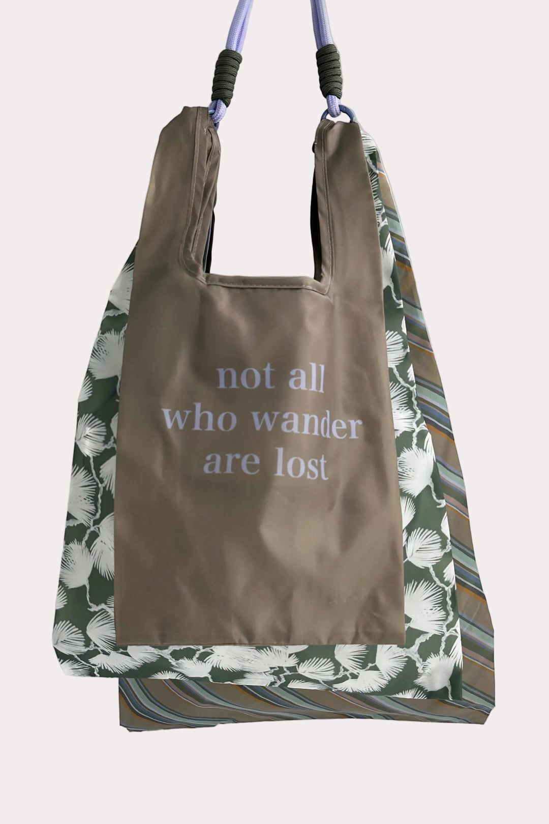 3 reusable bags with floral, striped pattern and text 'not all who wander are lost' on a white background