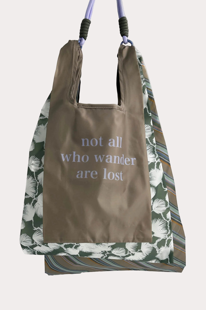 3 reusable bags with floral, striped pattern and text 'not all who wander are lost' on a white background