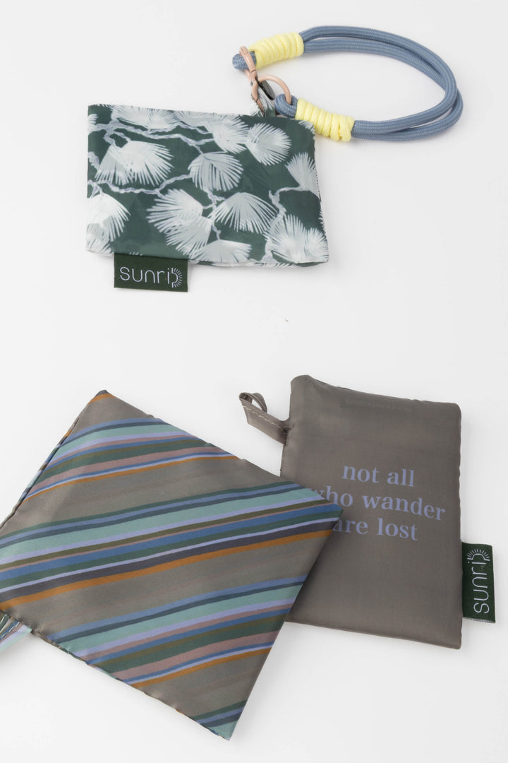 Three reusable bags with floral, striped, and motivational text designs on a white background.