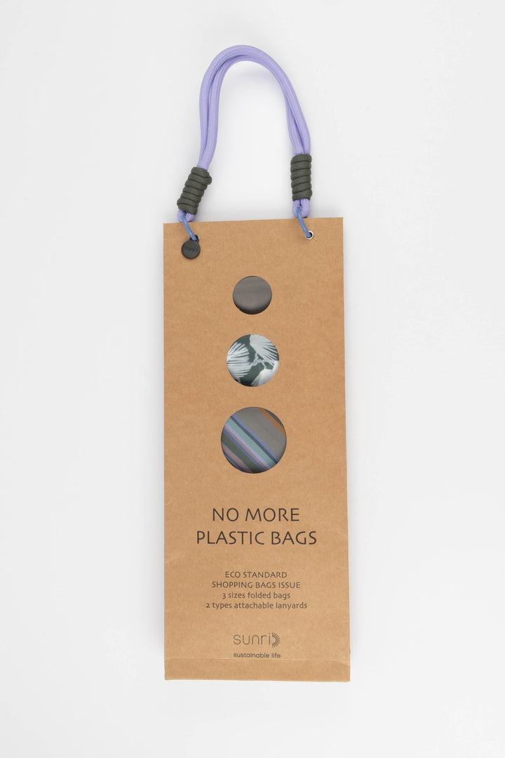 Cardboard packaging for shopping bags with colourful handles and visible branding 