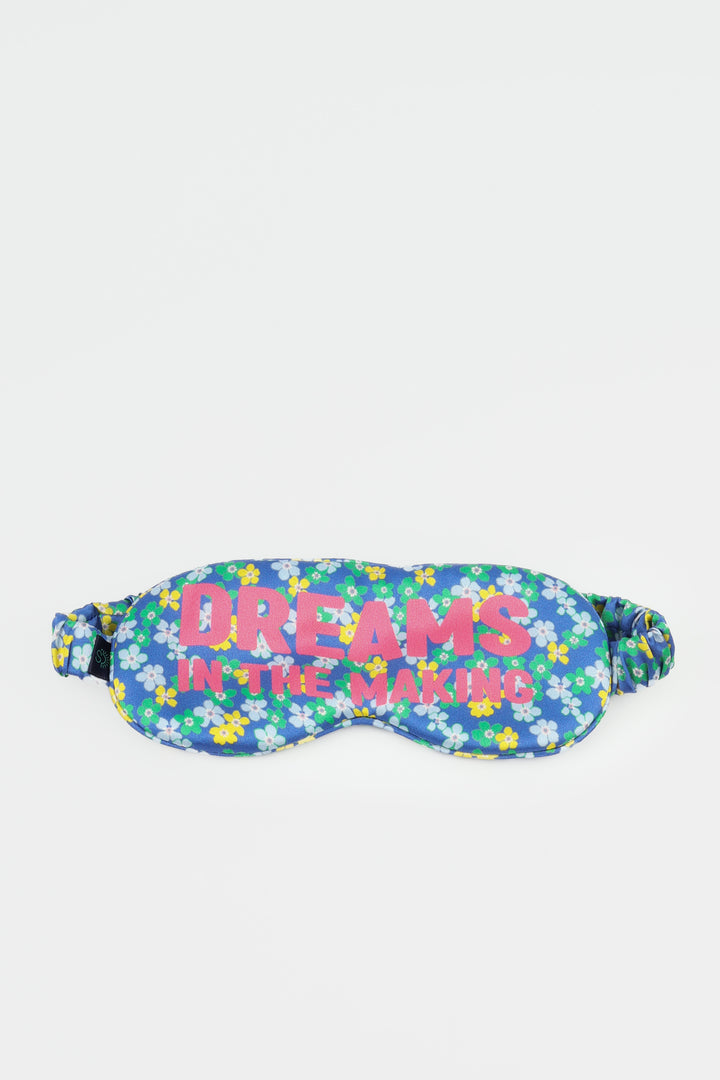 Floral patterned sleeping mask with 'Dreams in the Making' text on a white background