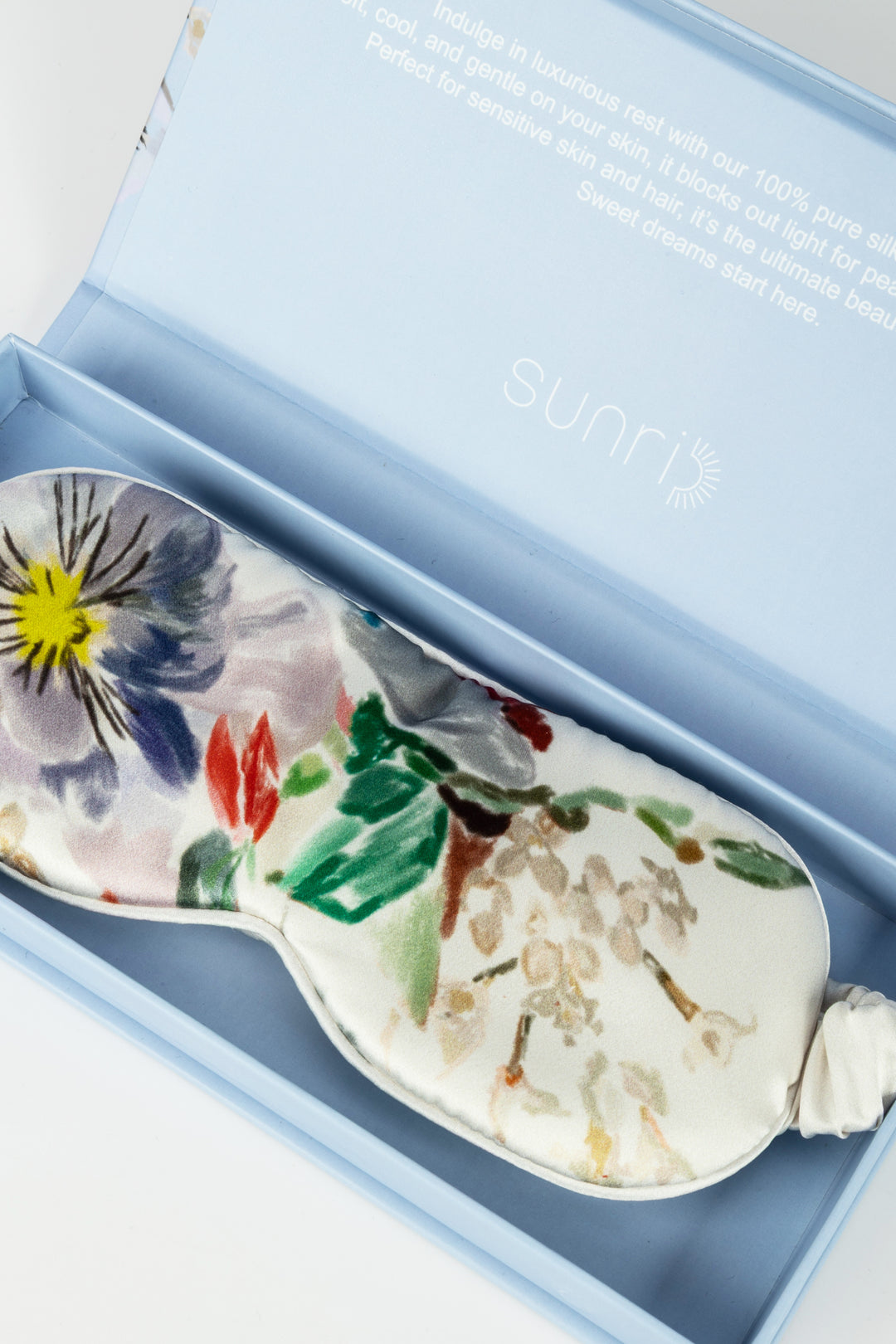 Decorative leeping mask with floral design in a blue box