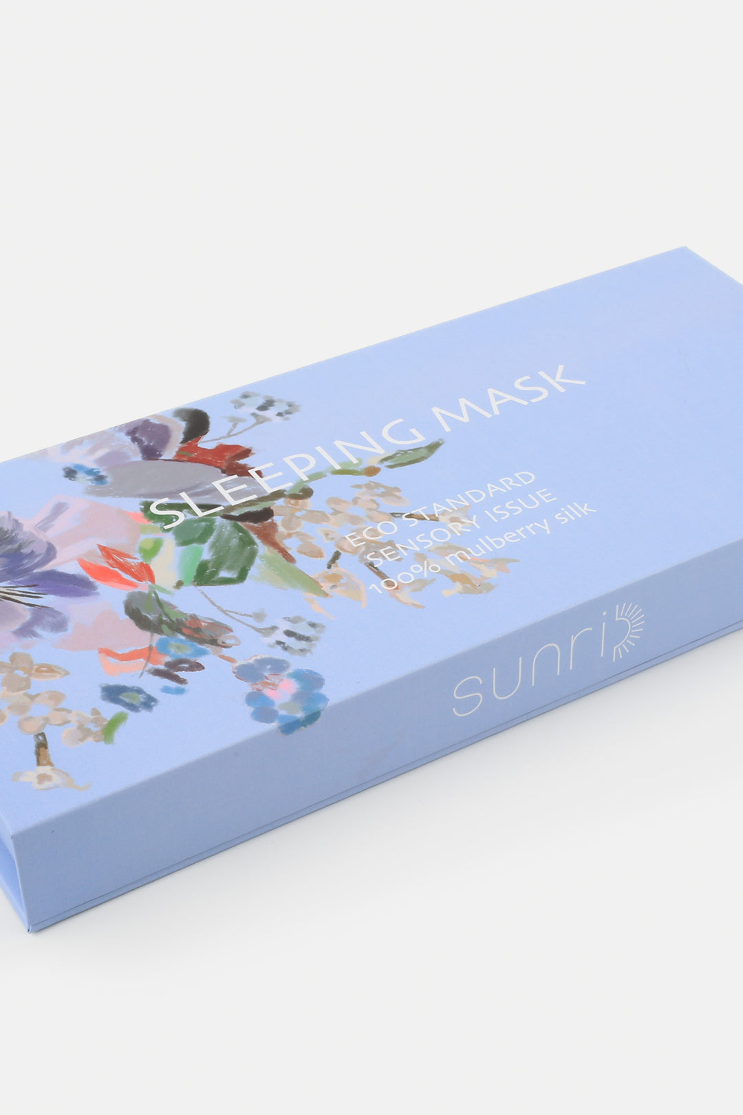 Blue box of sleeping mask with floral design on a white background
