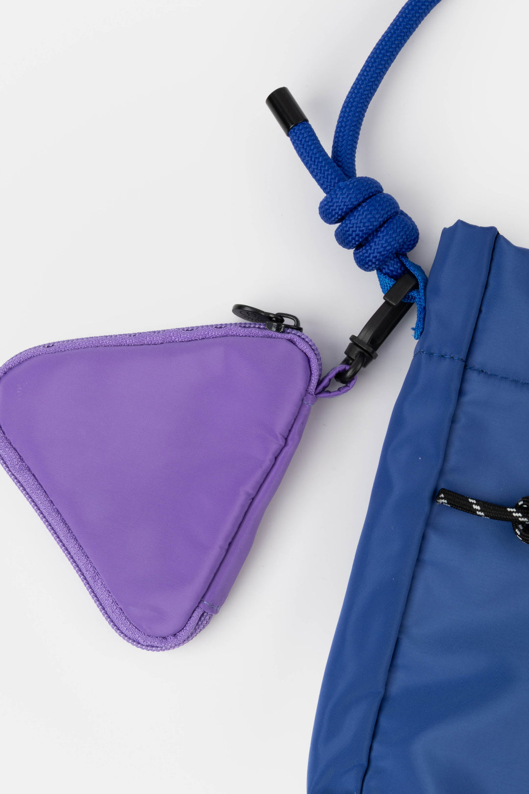 Blue bag with a purple triangle pouch attached on a white background
