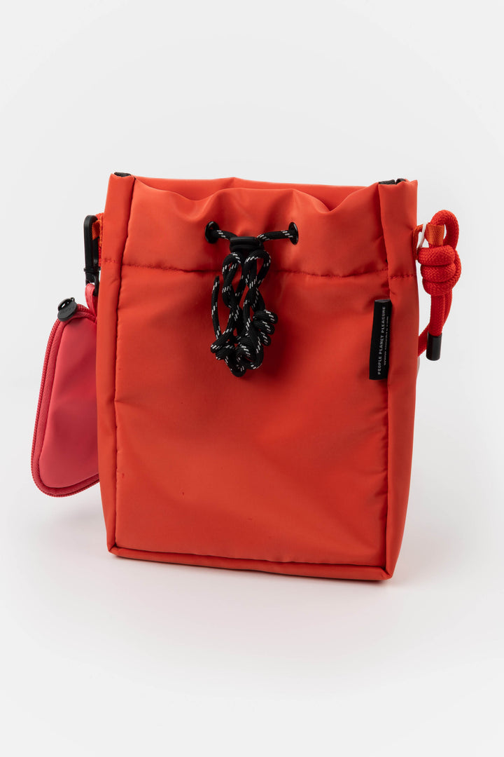 Red bag with a black chain on a white background
