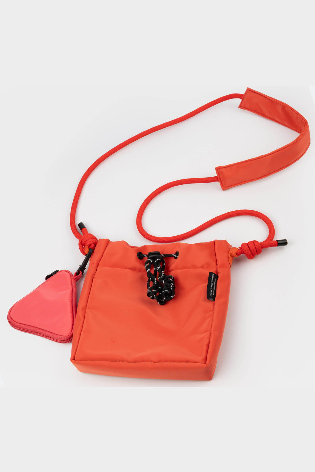red crossbody bag with a red strap on a white background