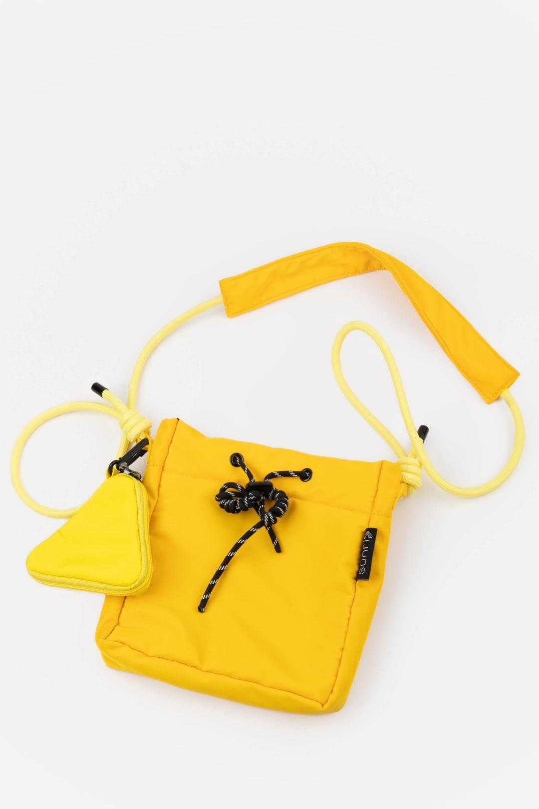 Yellow pouch with a black bow on a white background