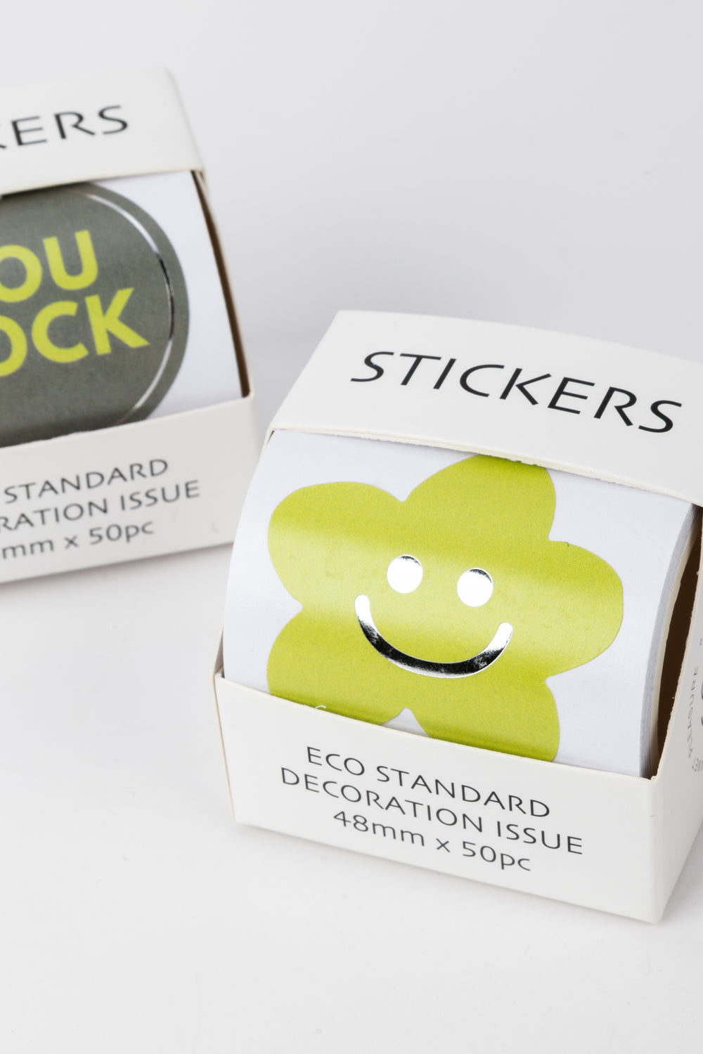 Box of stickers with a smiley face design on a white background