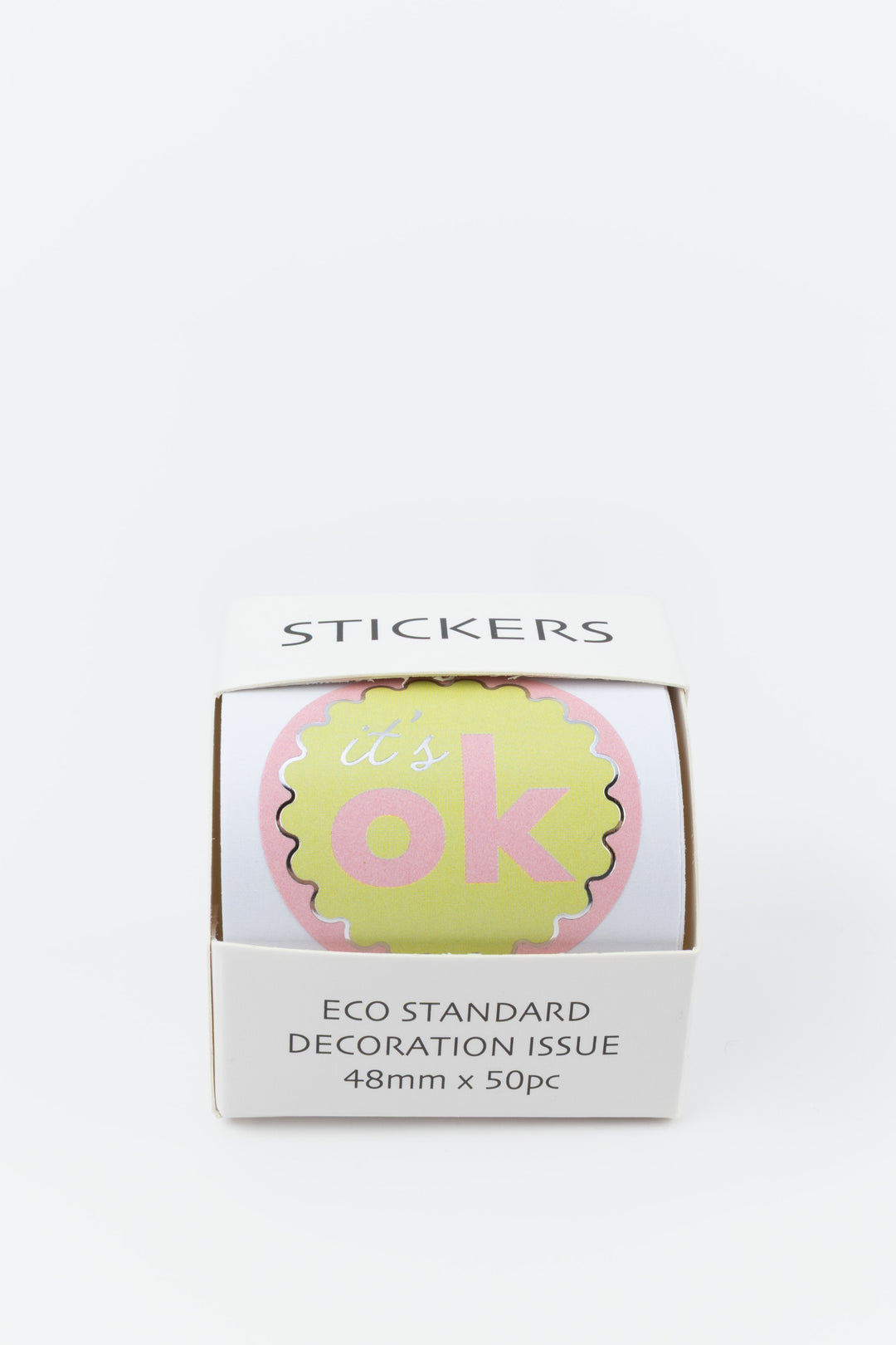 Box of 'it's ok' stickers with a pink and green design on a white background