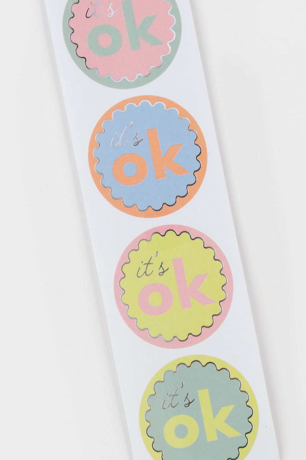 strip of 'it's ok' stickers in various colors on a white background