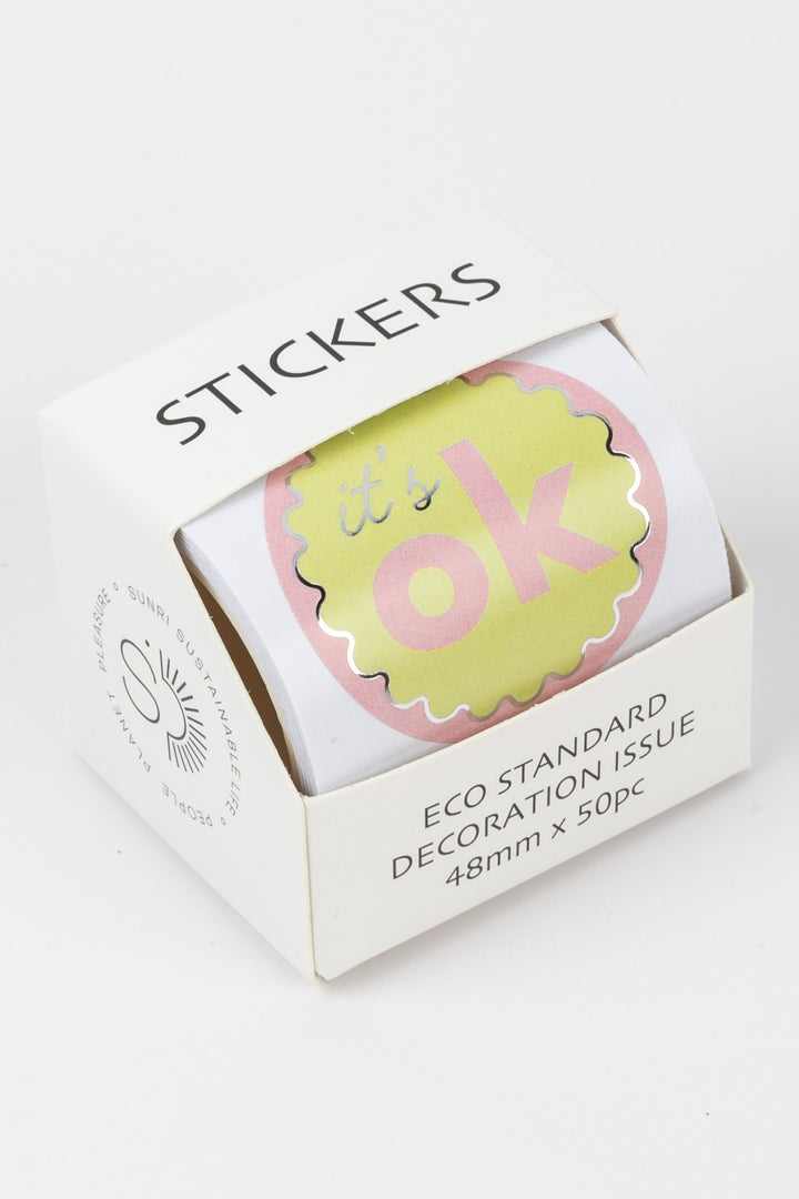 Box of stickers with a pink and yellow design on a white background