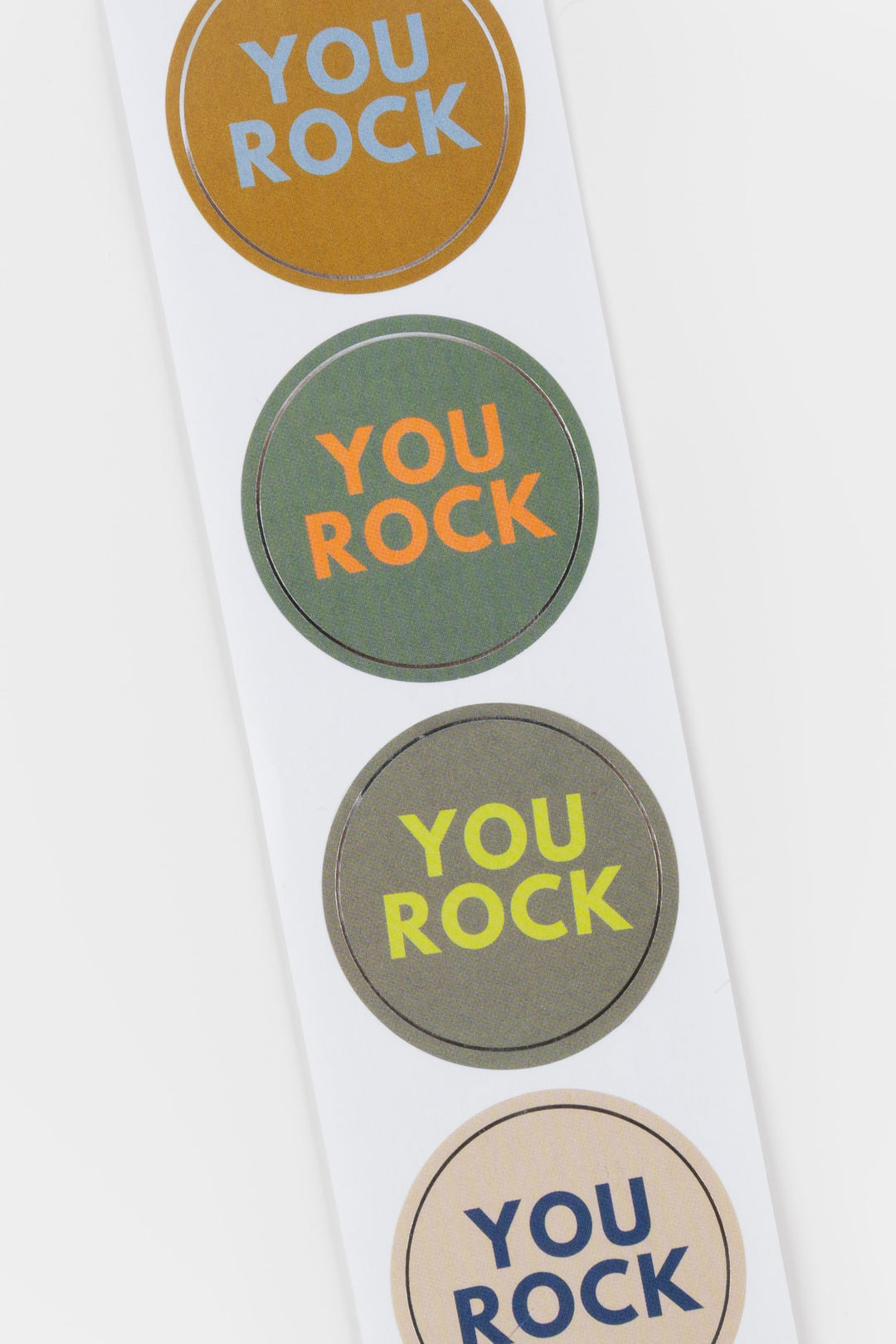 Set of 'YOU ROCK' stickers in different colors on a white background