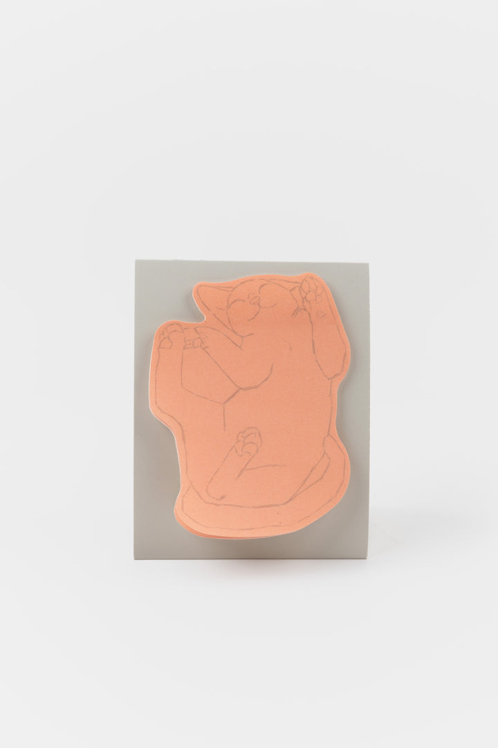 pink cat-shaped sticky note pad displayed on a standing card