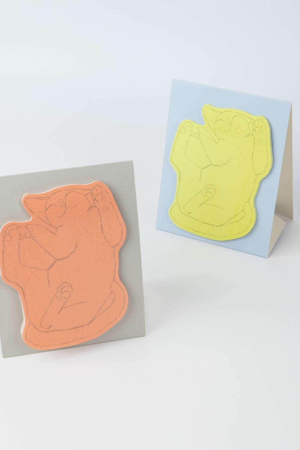 yellow and pink cat-shaped sticky note pad displayed on standing cards