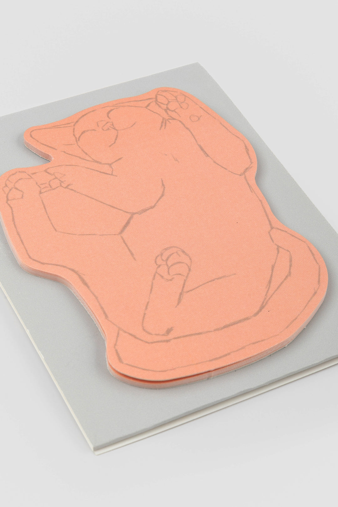 pink cat-shaped sticky note pad displayed on a card