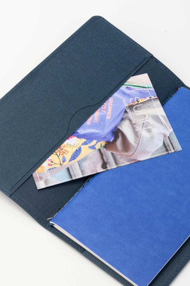 Blue sketch journal with a photo inside an open navy blue cover