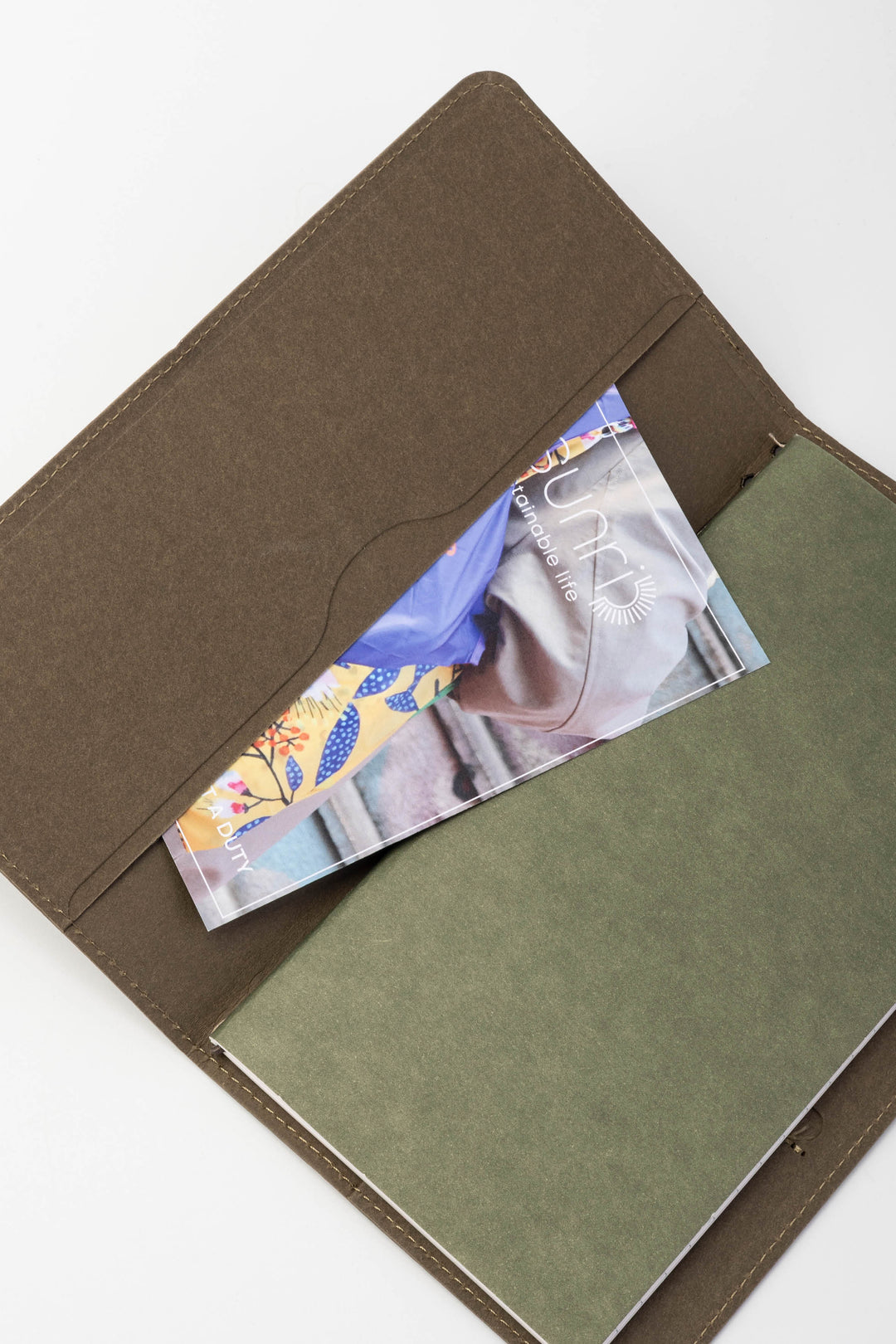 green sketch journal with a green inner lining and a card holder on a white background
