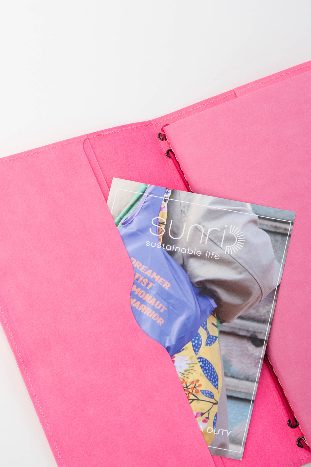 inside of pink sketch journal showing compartments for cards or notes