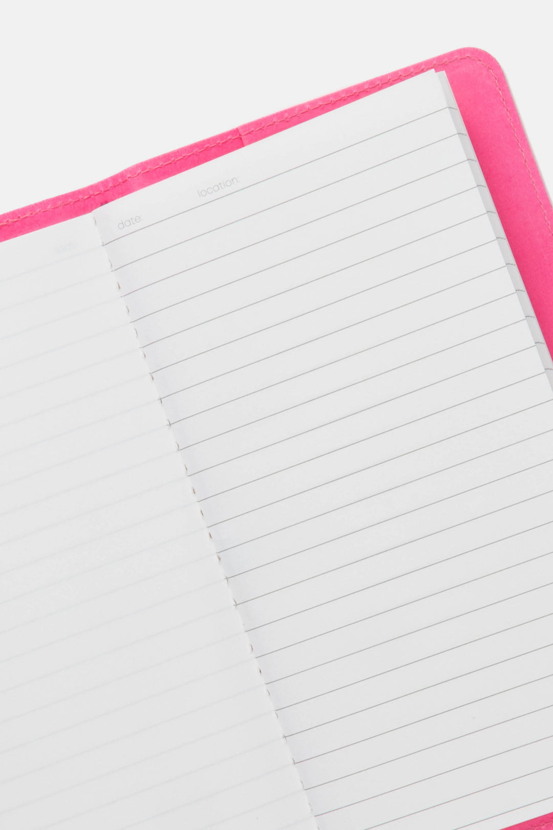 Open pink sketch journal showing ruled and blank pages