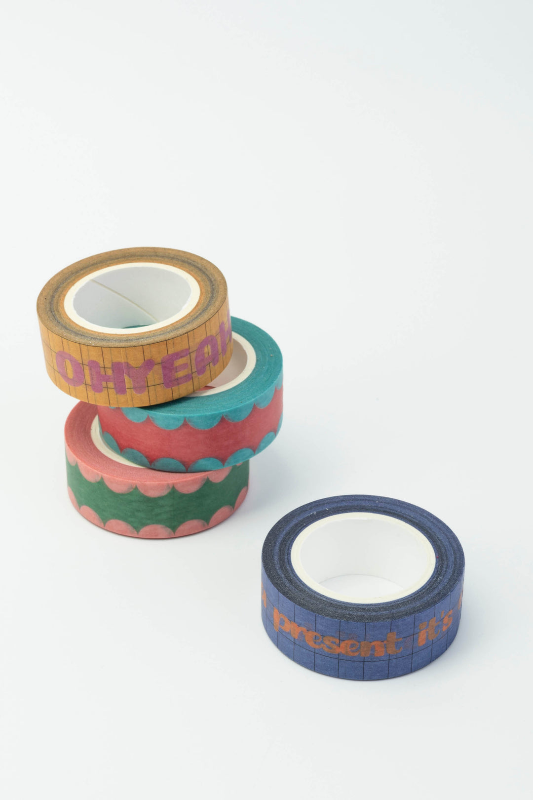 Four rolls of colorful tape with different patterns on a white background