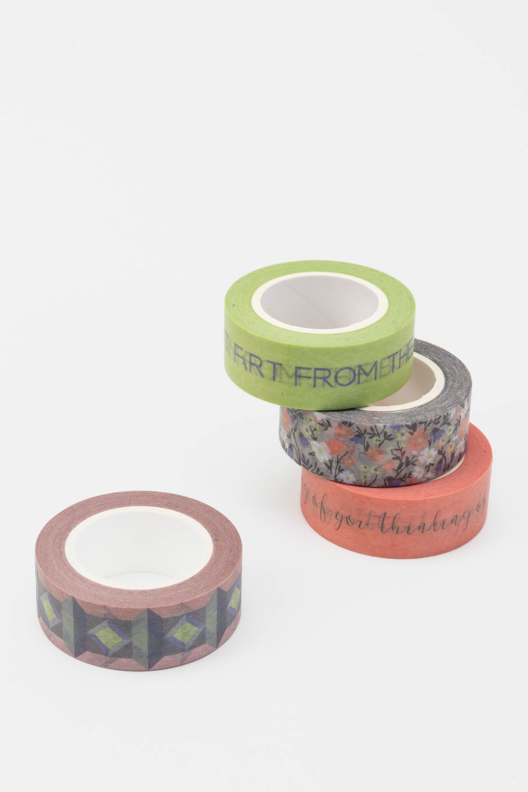 Four rolls of decorative tape with different patterns on a white background