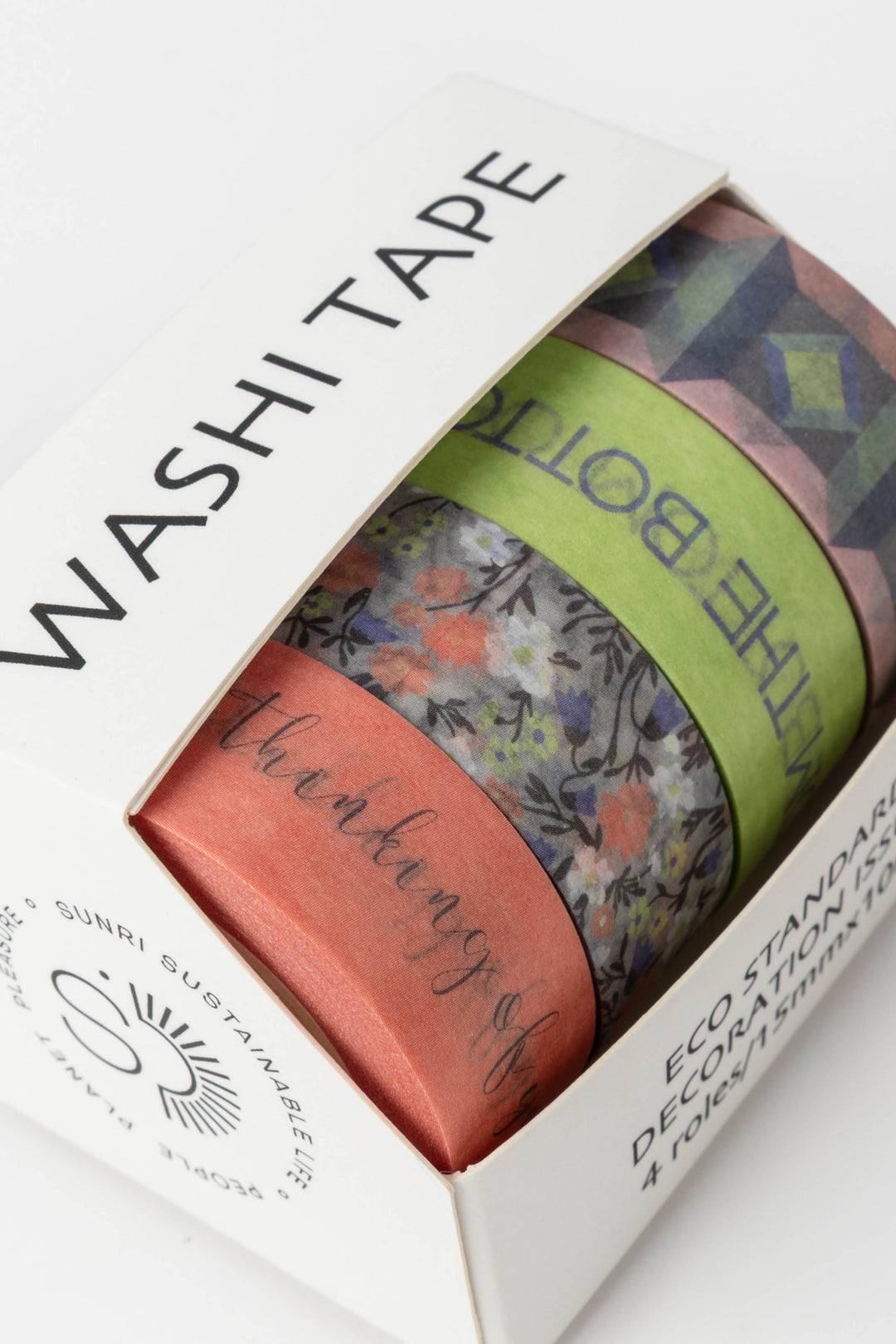 Box of washi tape with colorful designs and text on a white background