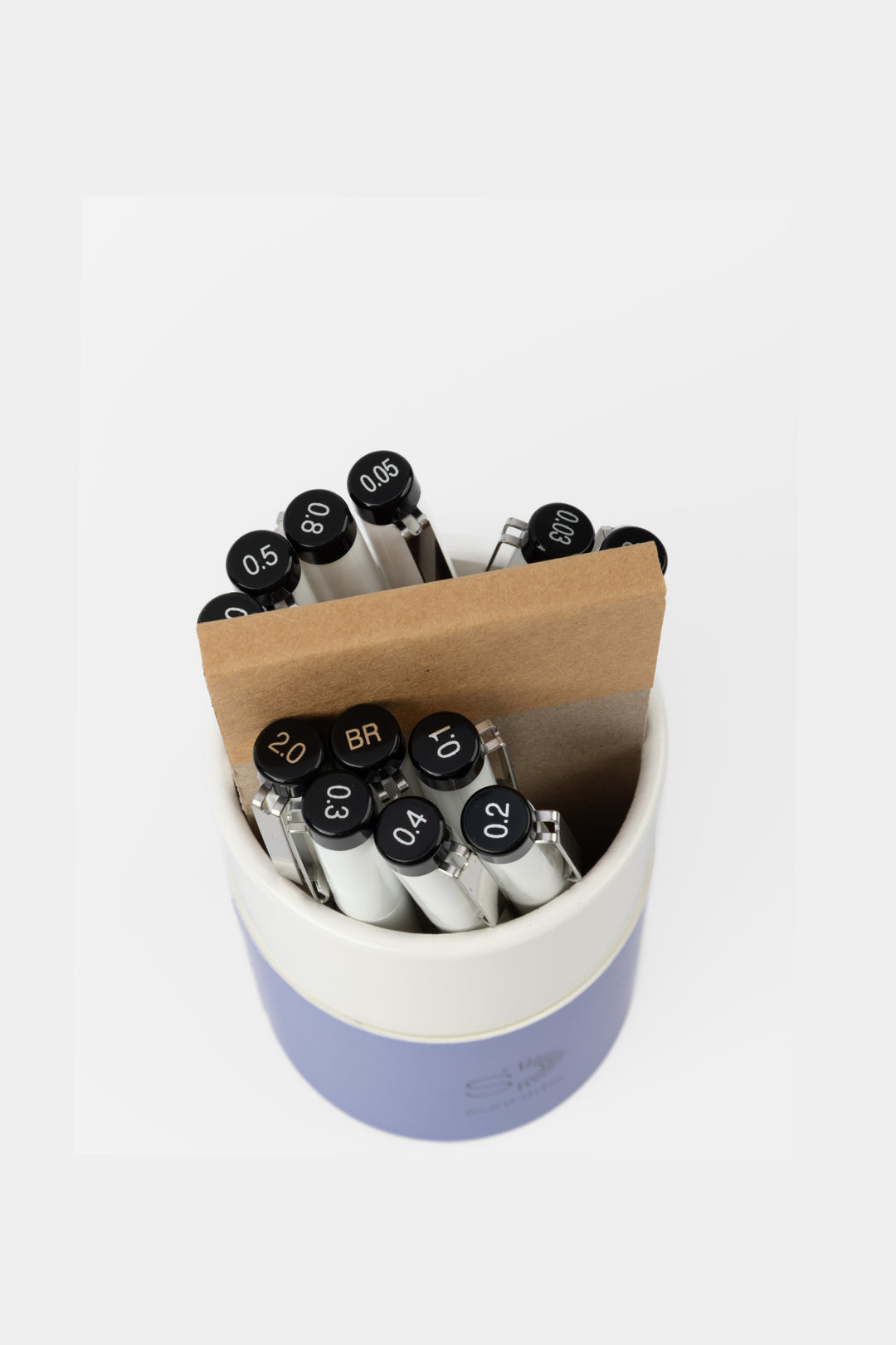 Set of markers in a blue holder with wooden top on a white background