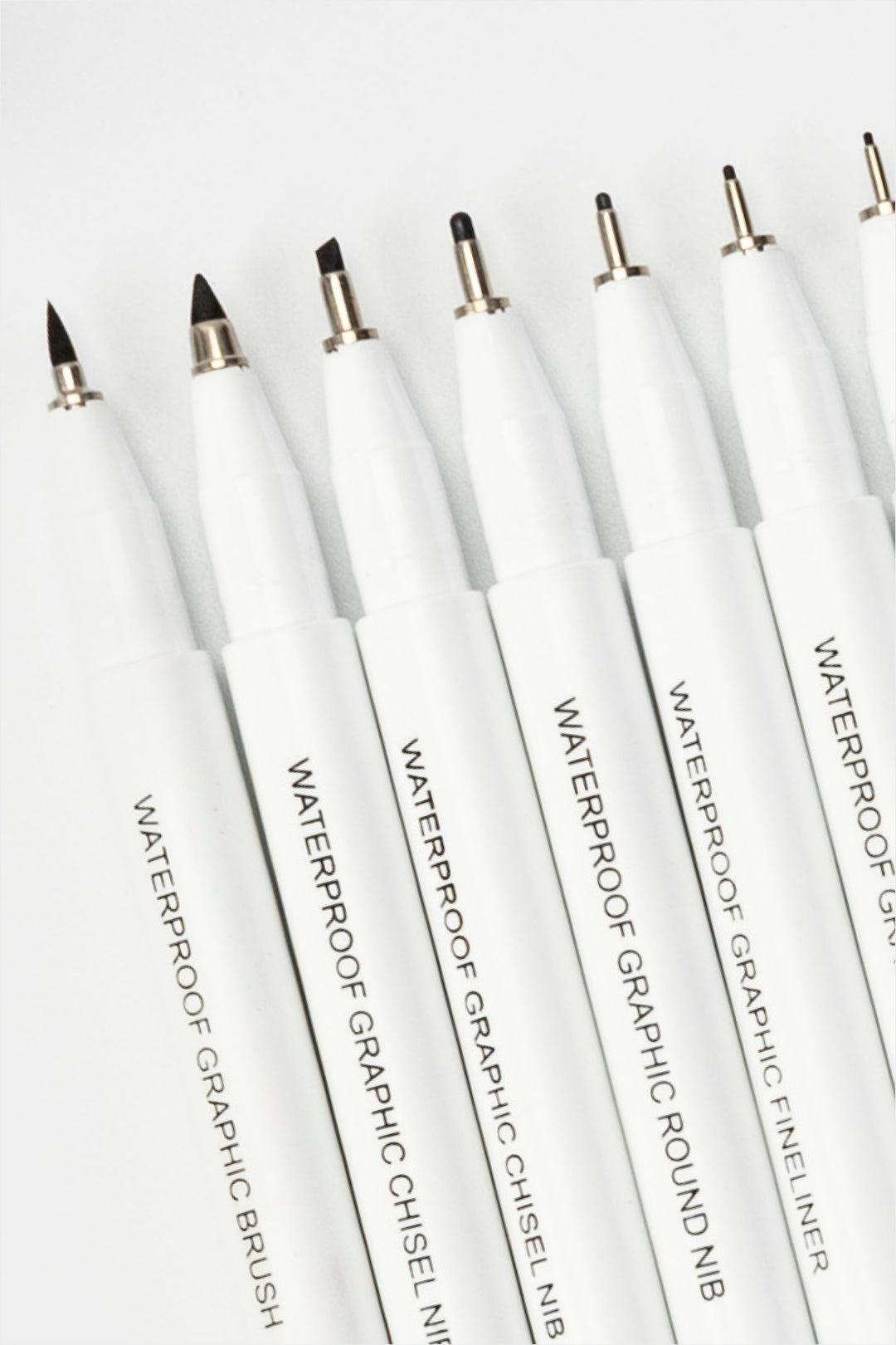 waterproof graphic pens close-up showing different nib shapes including brush, chisel and fineliner tips