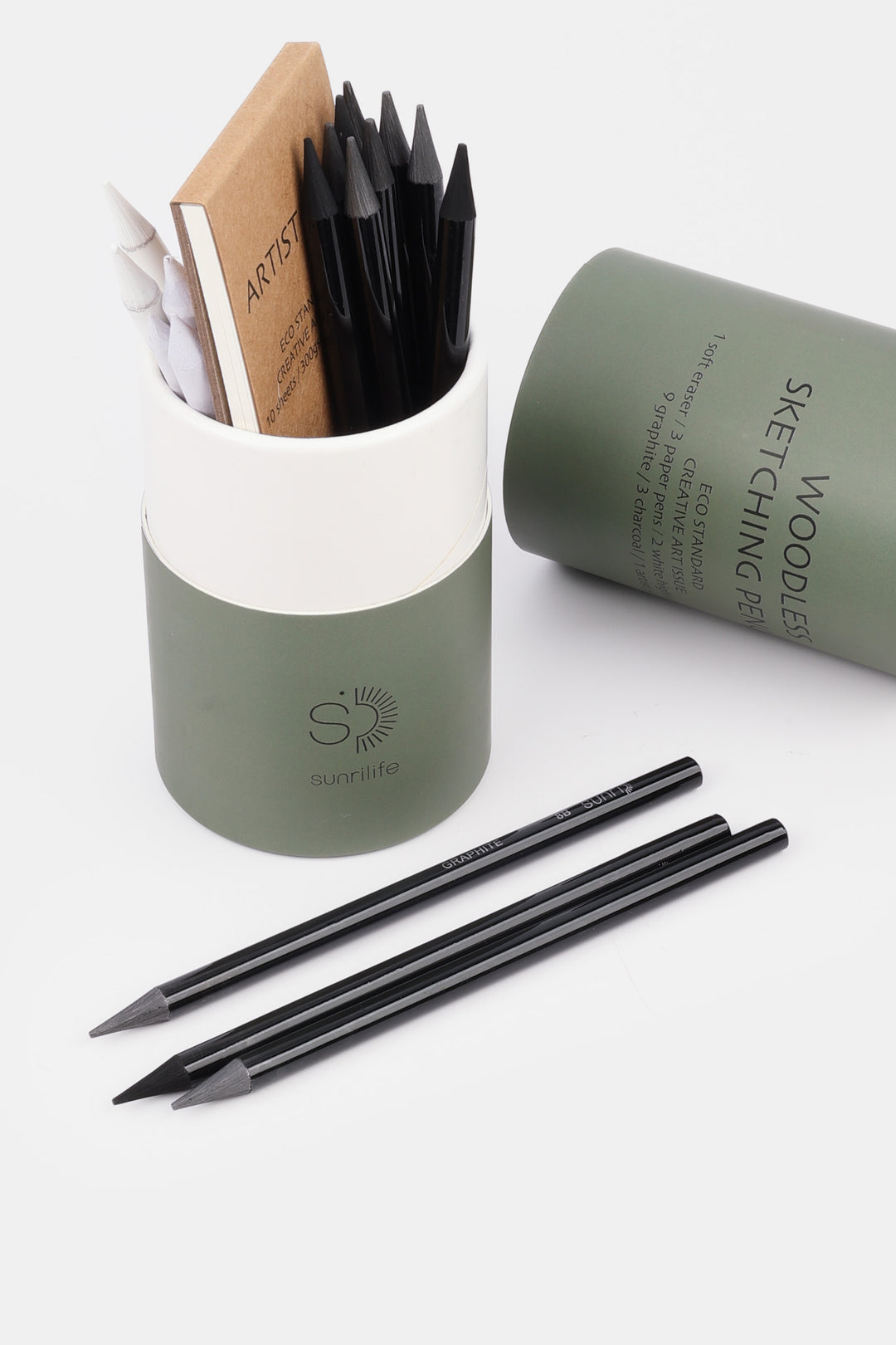 Set of black sketching pencils with a green holder on a white background